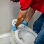 Adams Plumbing & Drain Company installing a new toilet in Alpine Hills, AL