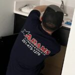 Adams Plumbing & Drain Company technician performing pipe repair in Second Creek, AL bathroom