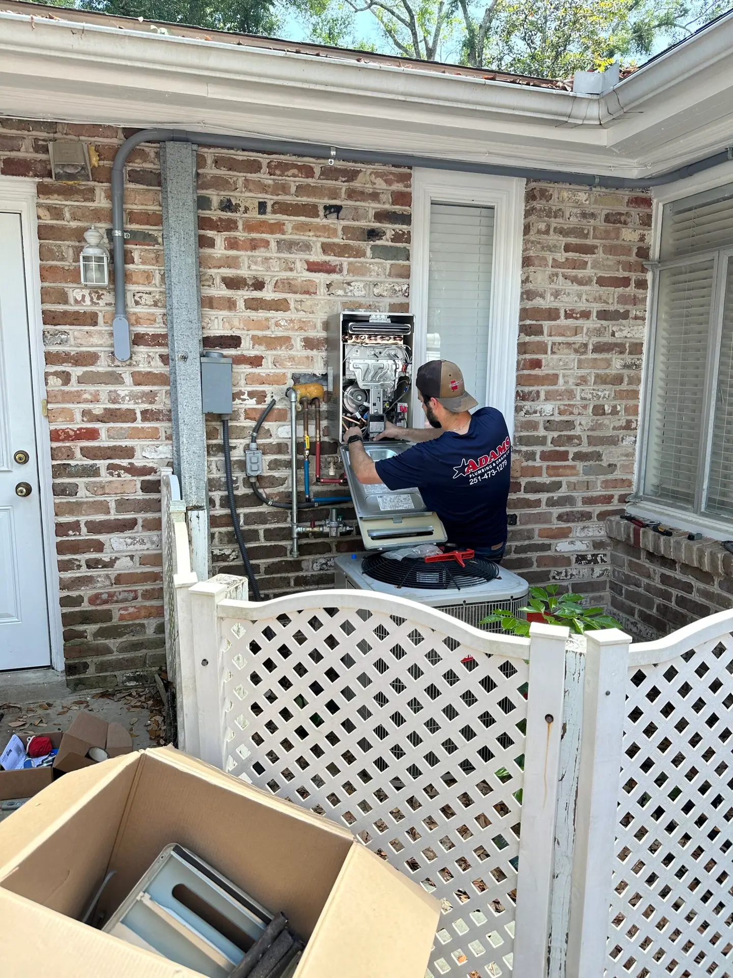Adams Plumbing & Drain Company installing a tankless water heater in Wheelerville, Mobile, AL