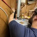 Adams Plumbing & Drain Company technician installing a water heater in Mobile, AL
