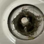 Plumber clearing a clogged drain in Devonshire, AL for Adams Plumbing & Drain Company