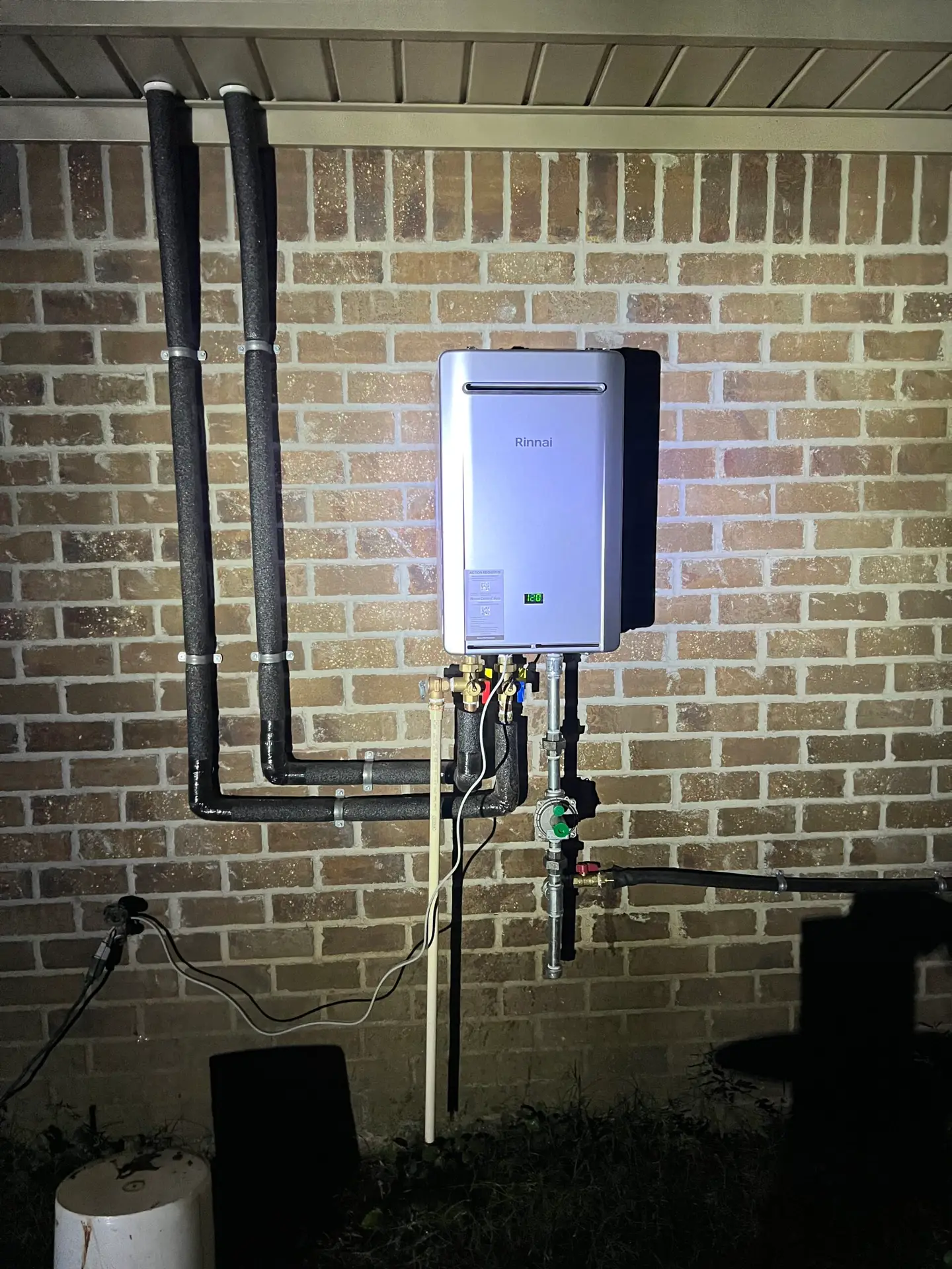Adams Plumbing & Drain Company installing a tankless water heater in College Park, AL